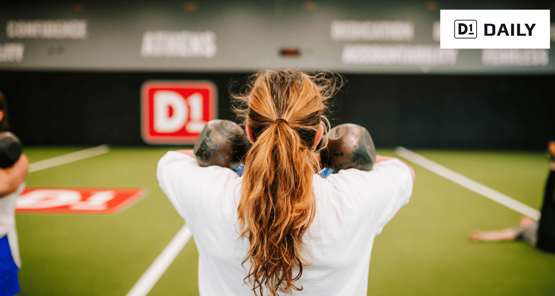 Woman lifting weights at D1 Athens